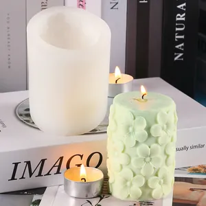 Vue détaillée d'un moule en silicone pour bougie avec relief floral et bougie finie