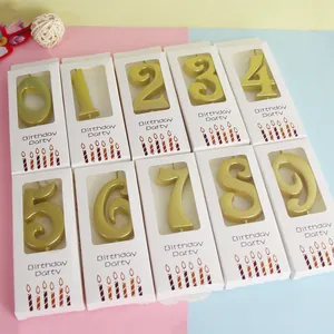 Close-up of gold number candles from 0 to 9 in individual birthday party gift boxes