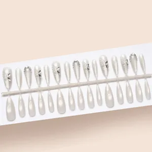 Detailed view of 30pcs milky white cat eye press-on nails with 3D butterfly charms