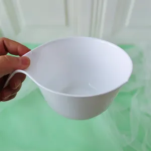 Detail shot of a white ergonomic mixing bowl for frosting and cream coloring