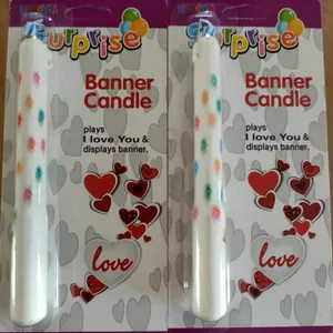 Close-up of surprise banner candle packaging with music and heart design for parties