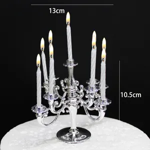 Silver plastic 9-arm candelabra for cake decoration, 13cm width and 10.5cm height.