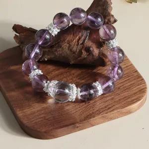 Macro detail of 12mm natural amethyst beads with decorative silver floral spacers