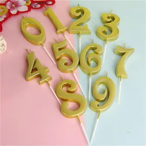 Detail view of metallic golden number 0-9 birthday candles for party cake decoration
