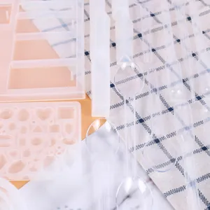 Close-up detail of resin casting mold kit including pipettes and spoons