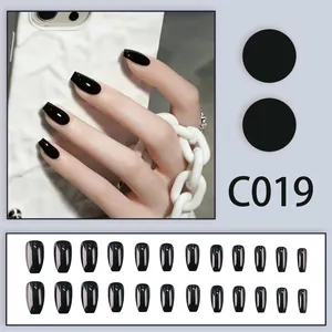 Glossy black short coffin press-on nails set with 24 pieces and model C019 detail