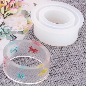 Close-up of translucent silicone mold and finished resin bracelet with dried flowers