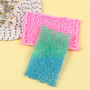 Detailed view of flexible blue gradient fondant lace on pink silicone texture mold