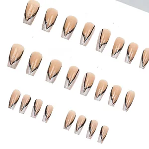 Macro detail of nude press-on nails with black V-lines and silver glitter finish.
