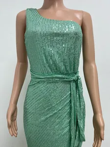 Close-up of mint green one-shoulder sequined maxi dress with waist tie and pleats