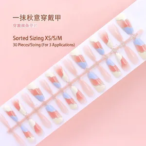 Detailed view of 30pcs press-on nail set with wavy design in peach, blue, and white colors.