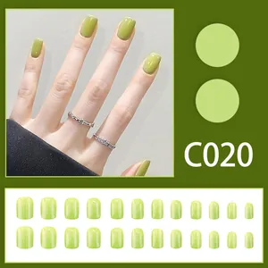 Detailed view of twenty-four pieces short green glossy press-on nails set with code C020