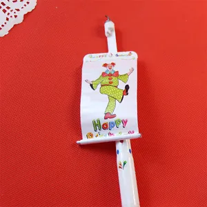Detailed close-up showing the colorful clown banner with Happy Birthday message on candle