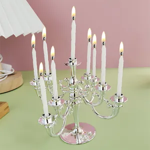 Vintage silver 9-arm plastic candelabra with nine lit candles for party decoration