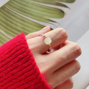 Detail of a handcrafted colorful tourmaline beaded ring with a square moonstone center.