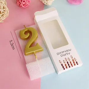 Detailed view of a gold number 2 birthday candle with 5.2cm height and packaging