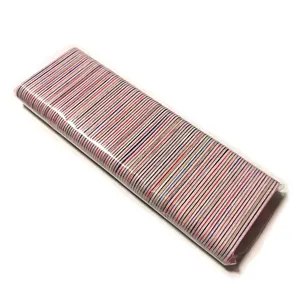 Macro view of mini double-sided wooden nail files showing colorful striped grit texture