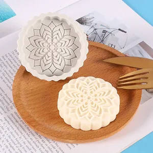 Detailed view of mooncake-shaped silicone mold with intricate floral mandala pattern.