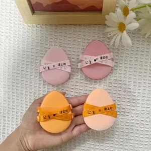 Professional four-piece set of egg-shaped makeup puffs in pink and orange with ribbon straps