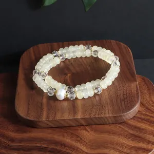 Macro view of a double-strand beaded bracelet with pale opal stones and a white pearl