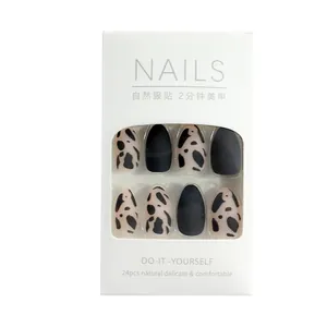 Set of 24 matte black and cow print press-on nails with natural delicate finish