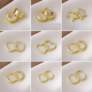 Grid view of various minimalist gold hoop earrings in star, heart, and geometric shapes.
