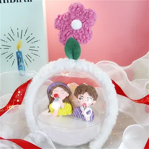 Detalle de figuritas de arcilla polimérica en una diadema de felpa floral decorada