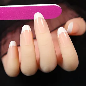 Detailed view of pink double-sided nail file smoothing elegant white French tip nails.