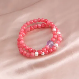 Elegant double-strand bracelet featuring pink jade beads, white pearls, and amethyst