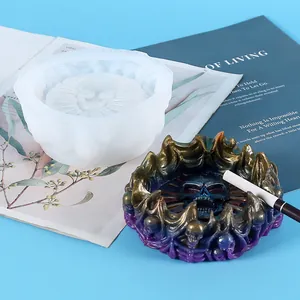 Detail showing a translucent silicone mold next to a skull-themed resin ashtray