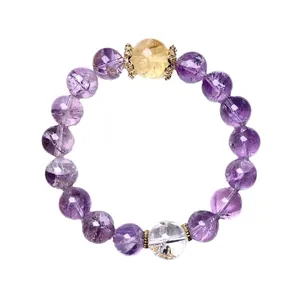 Natural purple amethyst beaded bracelet with clear quartz and golden spacers on white