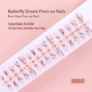 Close-up of butterfly and branch patterns on sparkling press-on nail strips