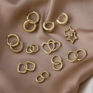 Detailed collection of small gold geometric hoop earrings in heart, star, and round shapes.