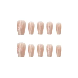 Close-up of nude gradient cat-eye press-on nails with white butterfly line art