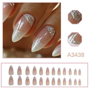 Detail view of nude pink French tip press-on nails with silver glitter accents.