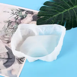 Close-up of translucent silicone mold with intricate leaf-shaped interior patterns
