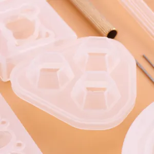 Close-up detail of hexagonal and bear-shaped silicone resin molds for DIY jewelry making