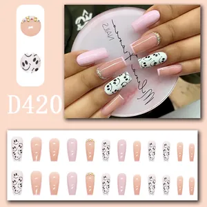 Pink and nude press-on nails set featuring smiley faces and rhinestone accents for DIY manicure