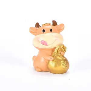Simpatica statuetta di mucca dorata in resina con sacco della ricchezza per torte e casa
