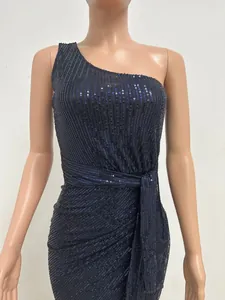 Close-up of dark navy one-shoulder sequined evening dress with elegant pleated waist tie.