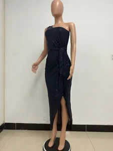 Detail of navy one-shoulder sequin dress featuring elegant ruching and waist tie.