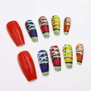 Detailed view of long press-on nails featuring a retro colorful sneaker shoelace design