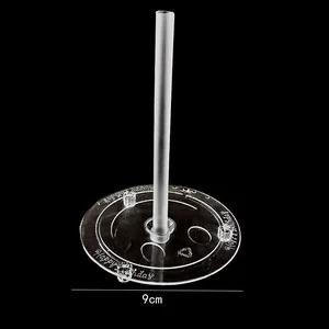 Detailed view of 9cm clear plastic cake support base with Happy Birthday engraving