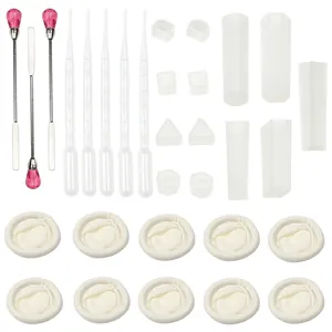 Detail view of DIY jewelry resin mold kit including silicone molds, pipettes, and mixing tools.