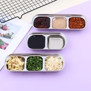 Detailed view of stainless steel seasoning dishes with compartments for sauces and spices
