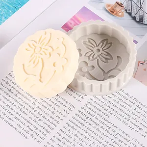 Macro view of a floral mooncake silicone mold and a finished cream aromatherapy cast.