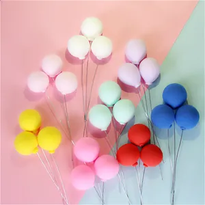 Detail showing various colors of miniature clay balloon cake toppers with wire stems