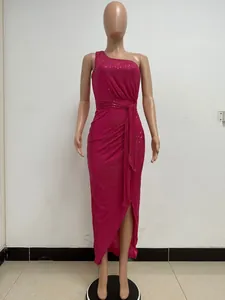 Close-up of fuchsia one-shoulder sequined evening dress with draped waist and side slit