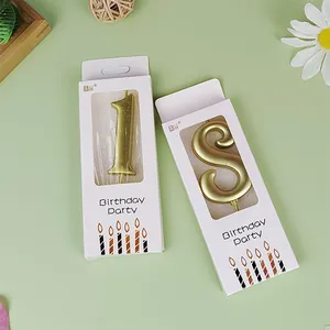 Elegant gold number birthday candles for party cake decoration in minimalist white packaging.