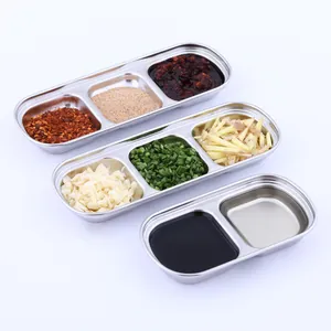 Detail showing 2 and 3 compartment stainless steel seasoning dishes with various spices